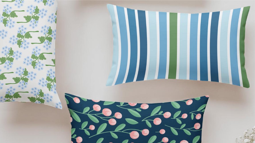 Custom-printed pillow cases and shams arranged on a bed